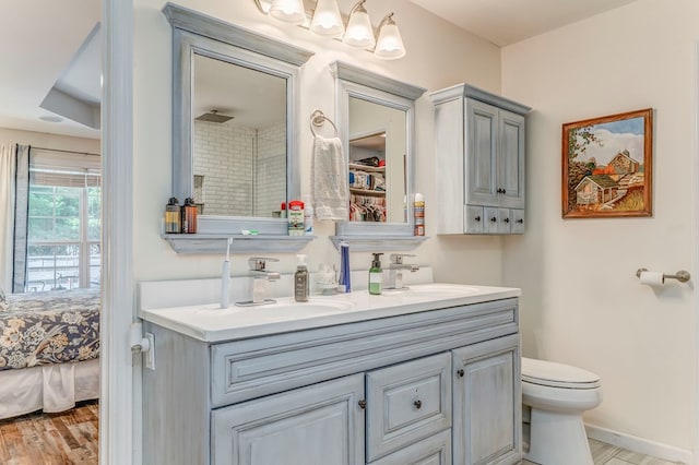 201 Tibbs Rd, Dalton, GA 30720 - bathroom with double vanity, toilet, wood finished floors, ensuite bathroom, and baseboards