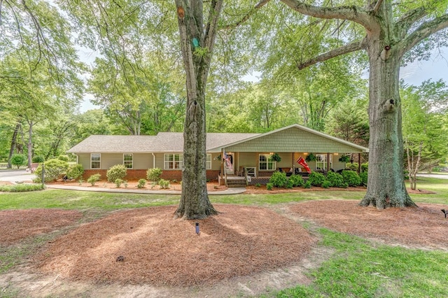 201 Tibbs Rd, Dalton, GA 30720 - ranch-style house featuring covered porch, brick siding, and view of wooded area