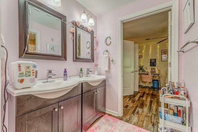 201 Tibbs Rd, Dalton, GA 30720 - full bathroom with double vanity, wood finished floors, and baseboards