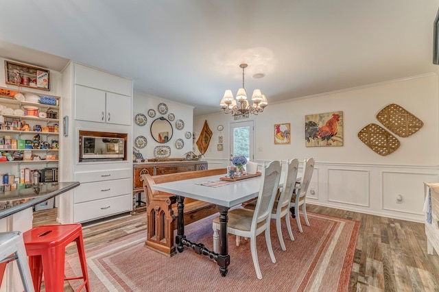 201 Tibbs Rd, Dalton, GA 30720 - dining area featuring a chandelier, light wood-type flooring, ornamental molding, a wainscoted wall, and a decorative wall