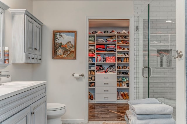 201 Tibbs Rd, Dalton, GA 30720 - bathroom with vanity, a stall shower, toilet, and wood finished floors
