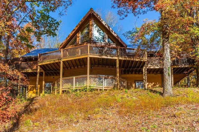 rear view of property with a wooden deck