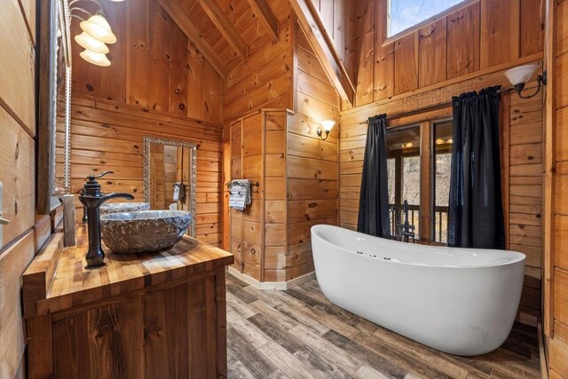 bathroom featuring sink, wooden walls, and toilet