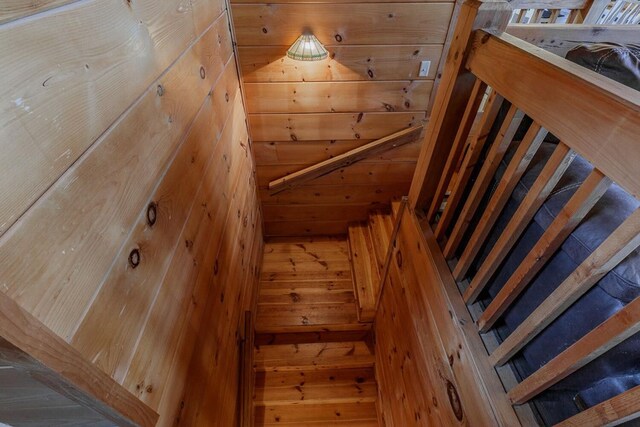 home office featuring ceiling fan, a barn door, and light hardwood / wood-style flooring