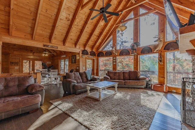 dining room with vaulted ceiling with beams, wooden walls, wooden ceiling, and light hardwood / wood-style floors