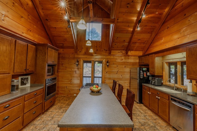 kitchen with decorative light fixtures, wood walls, sink, wood ceiling, and stainless steel appliances