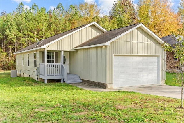 single story home with cooling unit, a garage, and a front yard