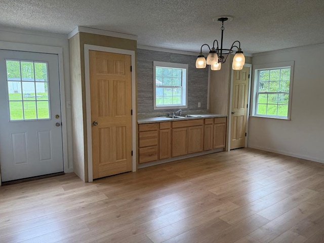 104 Riverview Dr, Dalton, GA 30721 - kitchen featuring a textured ceiling, a chandelier, light wood-type flooring, baseboards, and crown molding