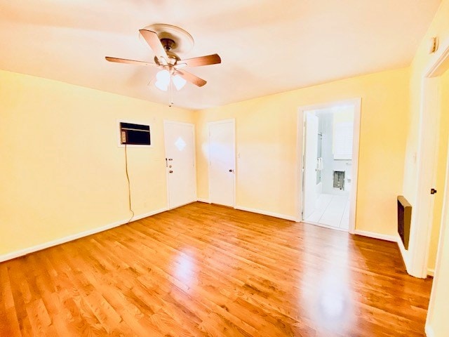 503 Williamsburg Dr, Dalton, GA 30720 - empty room featuring baseboards, an AC wall unit, ceiling fan, and light wood finished floors