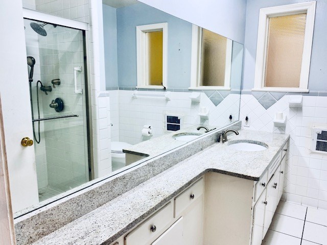 503 Williamsburg Dr, Dalton, GA 30720 - full bath featuring tile patterned flooring, a shower stall, tile walls, wainscoting, and vanity