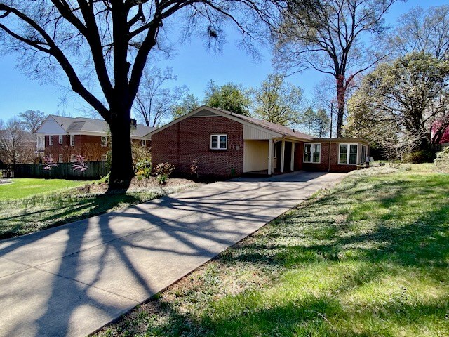 503 Williamsburg Dr, Dalton, GA 30720 - view of front of house with a carport, a front yard, brick siding, and driveway