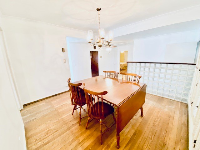 503 Williamsburg Dr, Dalton, GA 30720 - dining area with a notable chandelier, baseboards, and light wood finished floors