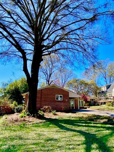 503 Williamsburg Dr, Dalton, GA 30720 - view of property exterior featuring a lawn and brick siding
