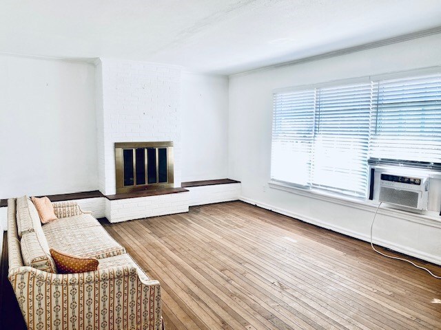 503 Williamsburg Dr, Dalton, GA 30720 - sitting room featuring a brick fireplace, cooling unit, and wood finished floors