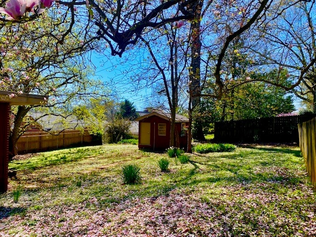 503 Williamsburg Dr, Dalton, GA 30720 - view of yard with an outdoor structure, a storage unit, and fence