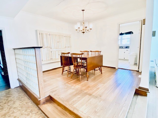 503 Williamsburg Dr, Dalton, GA 30720 - dining area with baseboards, an inviting chandelier, crown molding, and light wood finished floors