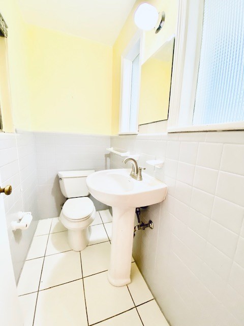 503 Williamsburg Dr, Dalton, GA 30720 - bathroom featuring tile patterned floors, toilet, tile walls, and a wainscoted wall