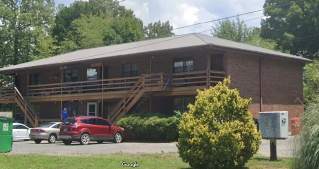 view of front facade with a wooden deck