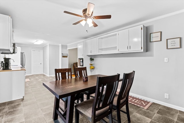 dining room featuring ornamental molding and ceiling fan