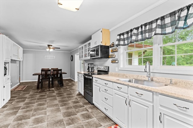 kitchen with sink, white cabinetry, ornamental molding, appliances with stainless steel finishes, and ceiling fan