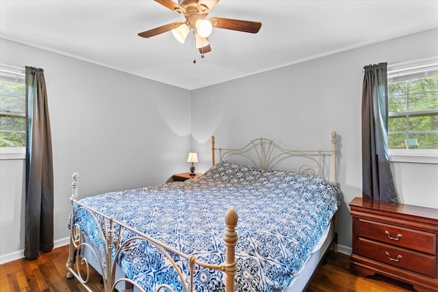 bedroom featuring ornamental molding, dark hardwood / wood-style floors, and ceiling fan