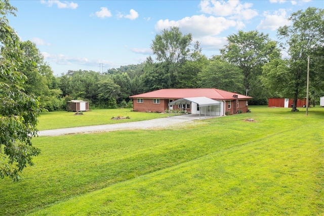 view of yard with a carport and a storage unit