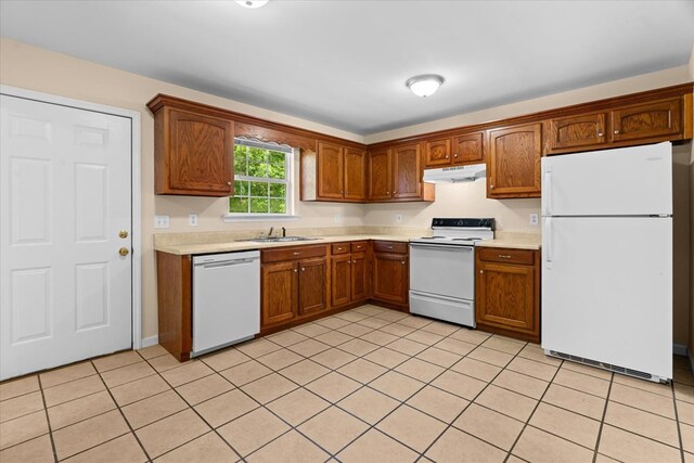120 Loudermilk Rd, Chatsworth, GA 30721 - kitchen with white appliances, under cabinet range hood, light countertops, and light tile patterned floors