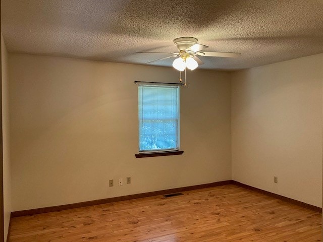 1403 Mack St, Dalton, GA 30720 - spare room featuring light wood finished floors, a ceiling fan, and a textured ceiling