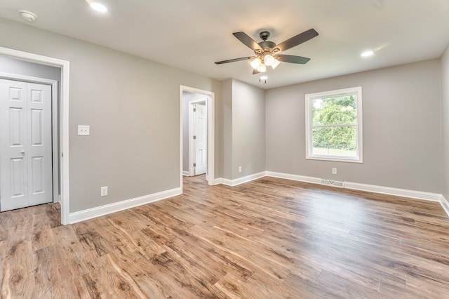 spare room featuring light hardwood / wood-style flooring and ceiling fan