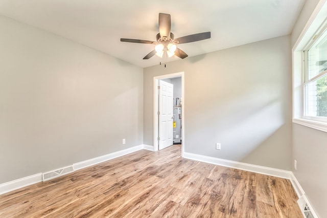 empty room with light hardwood / wood-style floors and ceiling fan