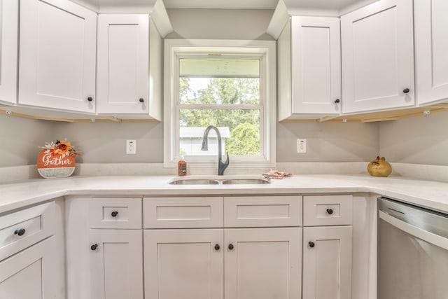 kitchen featuring white cabinetry, dishwasher, and sink