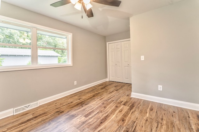 unfurnished room with ceiling fan and light wood-type flooring