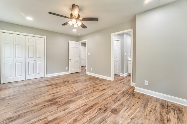 unfurnished bedroom featuring a closet, ceiling fan, and light wood-type flooring