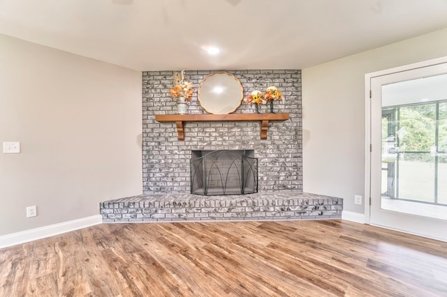 unfurnished living room featuring a fireplace and hardwood / wood-style floors