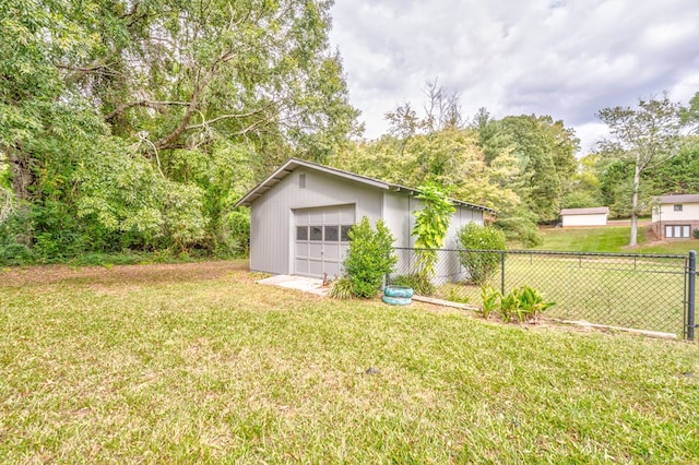 view of yard featuring a garage and an outdoor structure