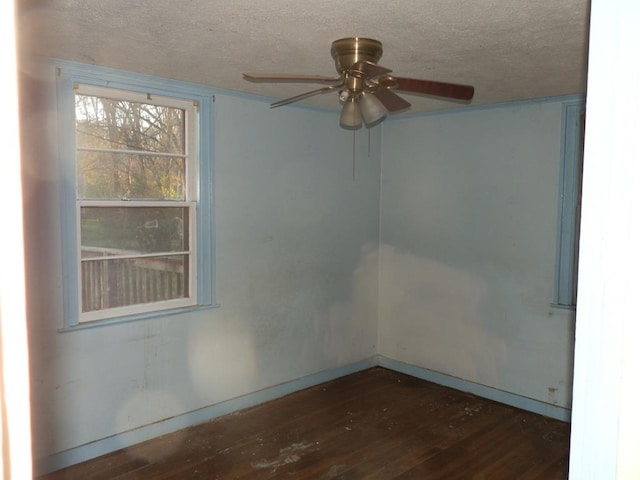 empty room featuring ceiling fan, a textured ceiling, and wood finished floors