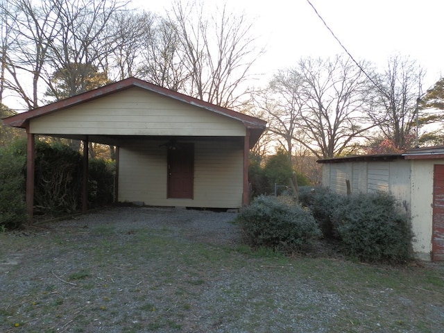 garage featuring a detached carport and driveway