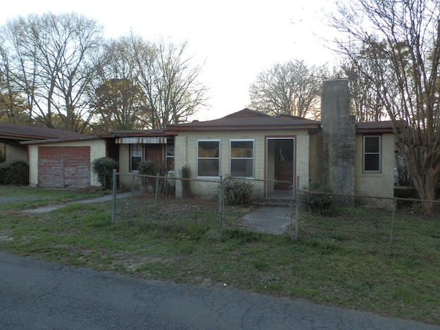 view of front facade with a fenced front yard and a garage