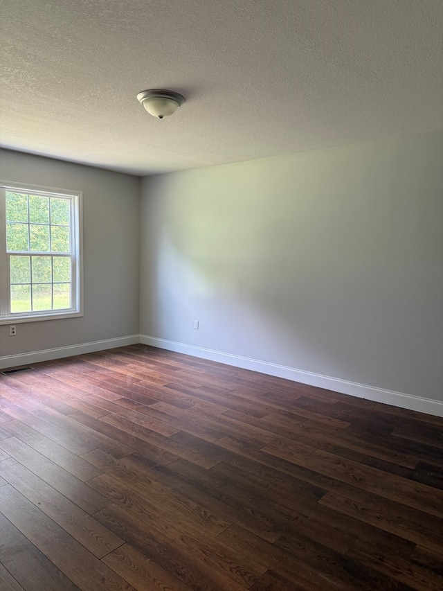 2305 Epperson Dr, Dalton, GA 30721 - spare room featuring dark wood-type flooring and a textured ceiling