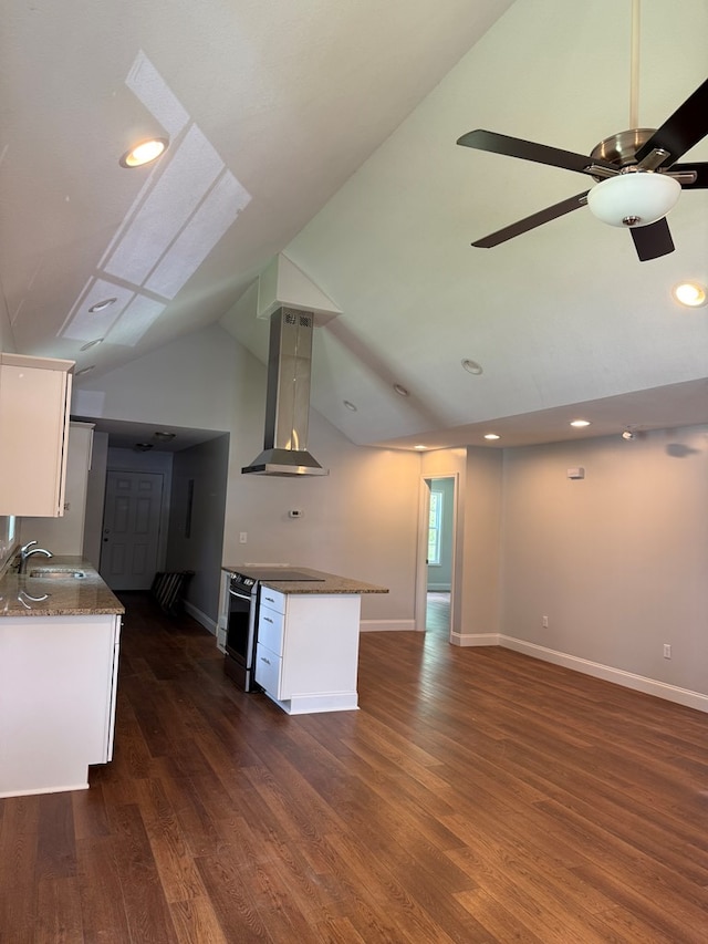 2305 Epperson Dr, Dalton, GA 30721 - kitchen with wall chimney exhaust hood, stainless steel range with electric stovetop, white cabinetry, dark wood-type flooring, and open floor plan