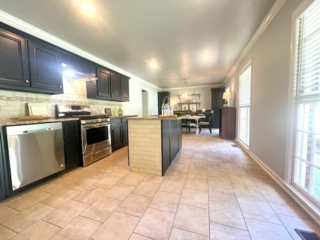 1229 Valencia Dr, Dalton, GA 30720 - kitchen with appliances with stainless steel finishes, ornamental molding, a center island, backsplash, and light tile patterned flooring