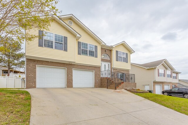 128 Andasol Way, Dalton, GA 30720 - bi-level home featuring brick siding, driveway, fence, and an attached garage