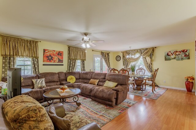 128 Andasol Way, Dalton, GA 30720 - living area with baseboards, wood finished floors, and ceiling fan with notable chandelier