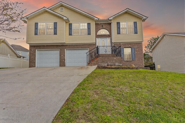 128 Andasol Way, Dalton, GA 30720 - split foyer home featuring fence, a garage, a lawn, brick siding, and driveway