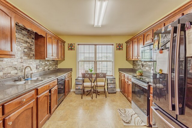 128 Andasol Way, Dalton, GA 30720 - kitchen featuring decorative backsplash, electric stove, a sink, freestanding refrigerator, and brown cabinets