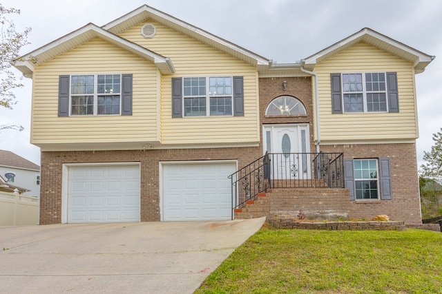 128 Andasol Way, Dalton, GA 30720 - split foyer home with a front yard, brick siding, concrete driveway, and a garage