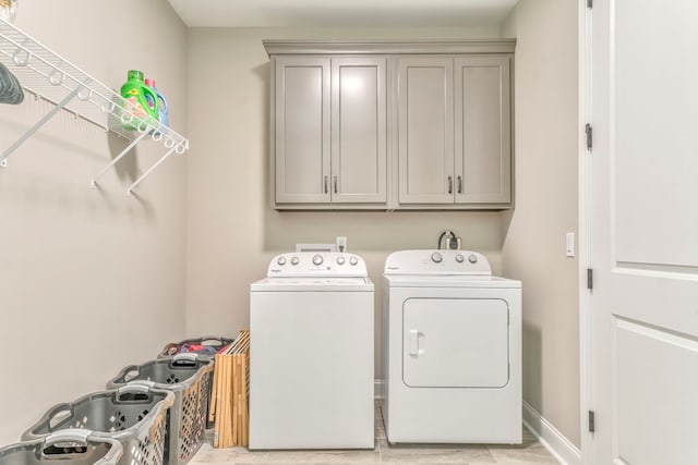 laundry room with cabinets and washing machine and dryer