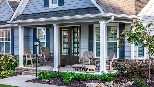 property entrance with a porch and french doors