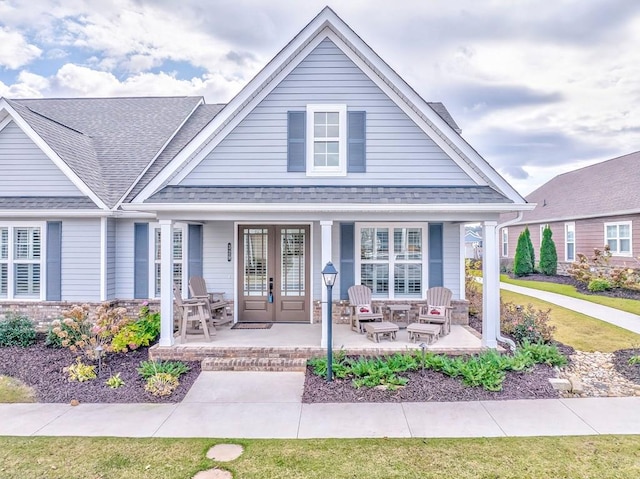 view of front facade featuring french doors and a porch