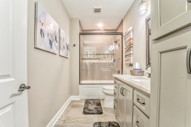 full bathroom with vanity, enclosed tub / shower combo, and toilet